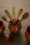 Wooden kitchen utensils as clay pots, wooden spoons and shovels on wooden table