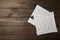 Wooden kitchen utensils, cutting board, potholder and glove on the table.