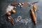 Wooden kitchen utensils with spices and recipe word