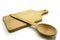 Wooden kitchen utensils on white background. Handcrafted cutting board and spoon