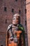 Wooden knight sculpture against brick wall of teutonic medieval castle from XIV and XV century
