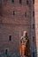 Wooden knight sculpture against brick wall of teutonic medieval castle from XIV and XV century