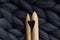 Wooden knitting needles on background of grey merino wool blanke