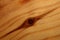 Wooden lacked brown surface macro close abstract texture plate of pine wood with a branch eye knot hole background brown yellow