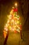 The wooden ladder decorated with Christmas lights. The shape of