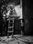 A wooden ladder leaning against the balcony in an abandoned dilapidated theater building