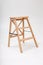 Wooden ladder in white emty room or on studio cyclorama with soft shadow
