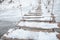 Wooden ladders covered by snow