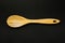 Wooden Ladle on a Clean Black Background