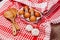 Wooden ladles and eggs on a red and white table rug