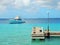 Wooden landing stage on Bonaire in the Caribbean with a motorboat in the back