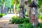 Wooden lanterns adorned in gardens along sidewalk in the park