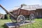 Wooden large cart on the background of a wooden house. Vintage