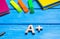 Wooden letter A plus on the student`s desk. School supplies on a blue wooden table. The concept of higher school assessment, good