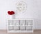 Wooden letters forming word LOVE in modern shelf, flowers and vi