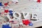 Wooden letters are laid out in the word love, July 4, happy independence day, patriotism, memory of veterans, the concept
