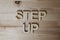 Wooden letters making the words Step Up