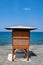 Wooden lifeguard safety station against blue water and sky