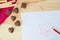 Wooden light background chocolate candy heart and gift tulips waffles, cloth moth polish dots paper