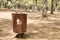 Wooden litter bin in the forest.