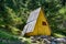 Wooden little yellow cottage in forest