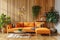 a wooden living room with an orange couch