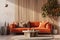 a wooden living room with an orange couch