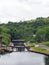 wooden lock gates on the calder and hebble navigation canal in front of the basin in sowerby bridge west yorkshire surrounded by