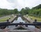 wooden lock gates on the rochdale canal outside mytholmroyd surrounded by trees and fields in the calder valley in west