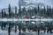 Wooden lodge in pine forest with heavy snow reflection on Lake O\'hara at Yoho national park