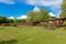 Wooden lodges sit amongst beautiful green grass