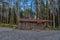 A wooden log cabin in pine forest