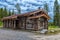 A wooden log cabin in pine forest