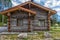 A wooden log cabin in pine forest