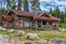 A wooden log cabin in pine forest