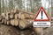 Wooden Logs - Trunks Of Trees Cut And Stacked - German Sign - Attention Tree Falling