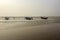 A wooden lonely fishing boat with few fishermen on Digha sea beach. Selective focus