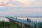 Wooden long bridge over a sea plait, river at sunset in perpektive, against a background of reeds, landscape