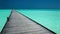 Wooden long jetty over lagoon in Maldives with amazing water