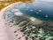 Wooden long-tail boat with coral reef on tropical beach at Lipe islands