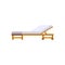 Wooden lounger for rest and sunbathing on sea beach or garden.