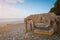 Wooden lounges and awnings with a cane roof on the seashore