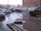 A wooden makeshift bridge over a street flooded with meltwater with stuck cars flooded the