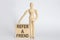 Wooden man shows with a hand text REFER A FRIEND concept on the wooden block