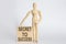 Wooden man shows with a hand text SECRET TO SUCCESS on wooden block