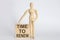 Wooden man shows with a hand text TIME TO RENEW concept on wooden block