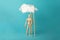 Wooden man and stepladder in clouds, career challenge and achievement. Progress and dream