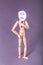 Wooden manikin standing with one hand on hip one hand holding up a sad face sign over his face