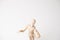 Wooden mannequin with doubtful gesture on white background - confusion and asking question concept