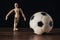 Wooden mannequin in focus, hand apart and down, Goalkeeper stance,